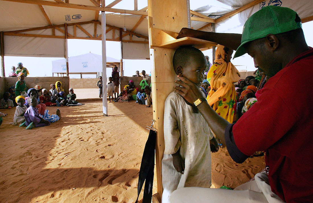 A young refugee from the Darfur region of Sudan has his height measured by health workers | Scott Nelson/Getty Images