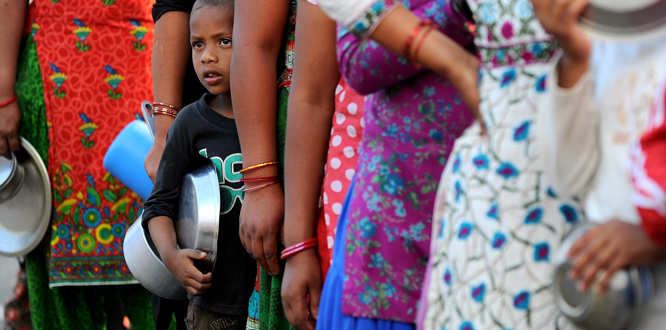 Young child waiting in line to get food