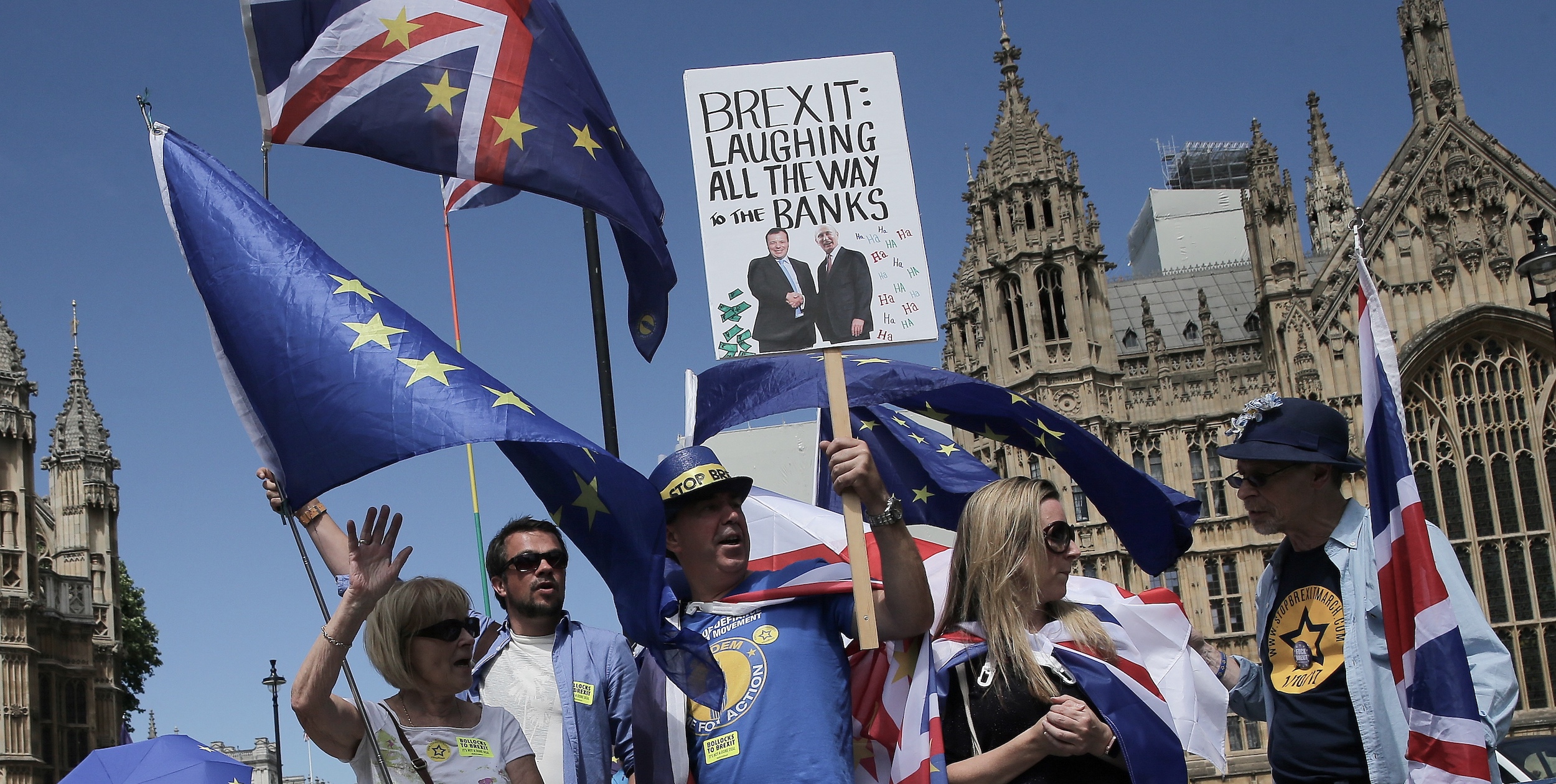 A pro-EU demonstrator holds a placard bearing an image of the co-founder of the pro-Brexit campaign group Leave.EU, Aaron Banks, and Russia's President Vladimir Putin. | DANIEL LEAL-OLIVAS/AFP via Getty Images