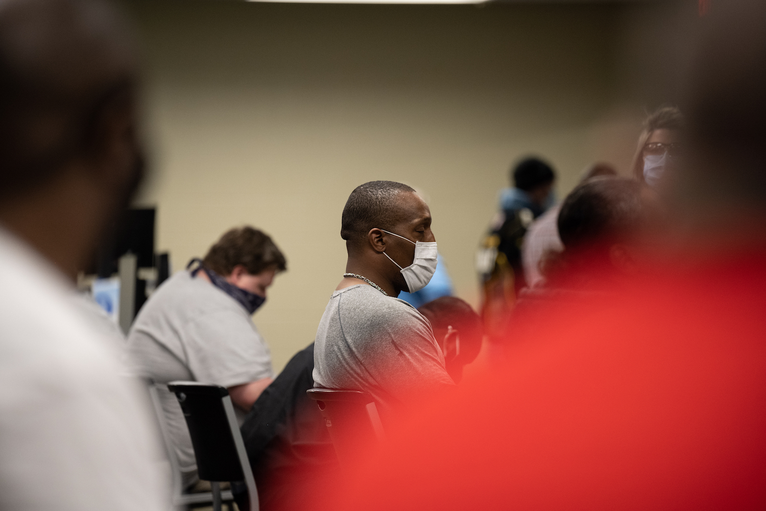 A man sleeps in the post-vaccination observation area after receiving his Johnson & Johnson COVID-19 vaccination at Wayside Christian Mission on March 15, 2021 in Louisville, Kentucky. | Jon Cherry/Getty Images