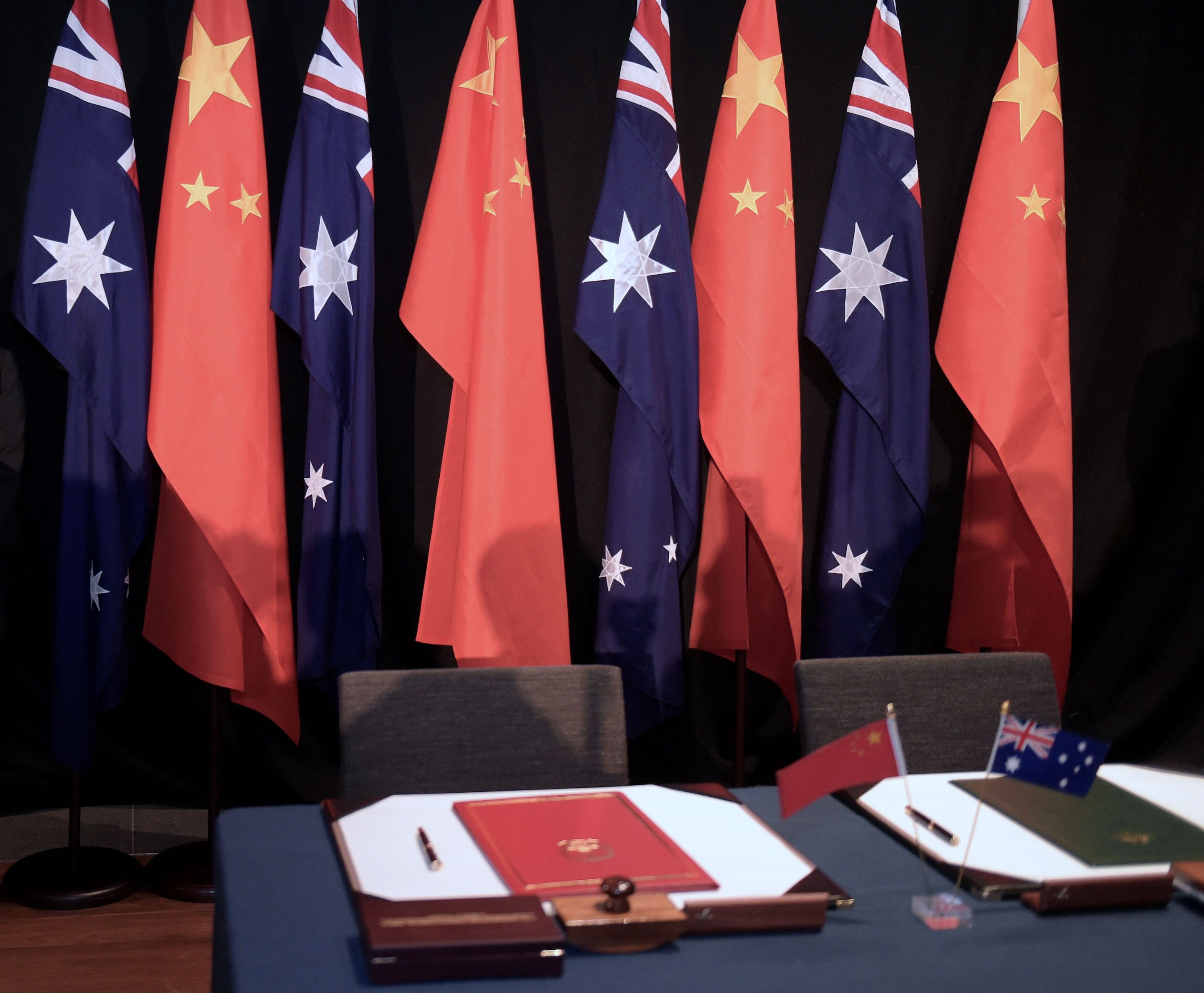 National flags of China and Australia during a signing ceremony on June 17, 2015 in Canberra, Australia. | Lukas Coch - Pool/Getty Images