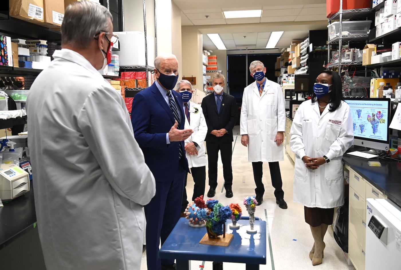 President Joe Biden tours the National Institutes of Health (NIH) in Bethesda, Maryland in February 2021, flanked by (from R) Dr. Kizzmekia S. Corbett, Dr. Francis Collins, White House COVID Coordinator Jeffrey Zients, White House Chief Medical Adviser on Covid-19 Dr. Anthony Fauci and Dr. Barney S. Graham. | SAUL LOEB/AFP via Getty Images