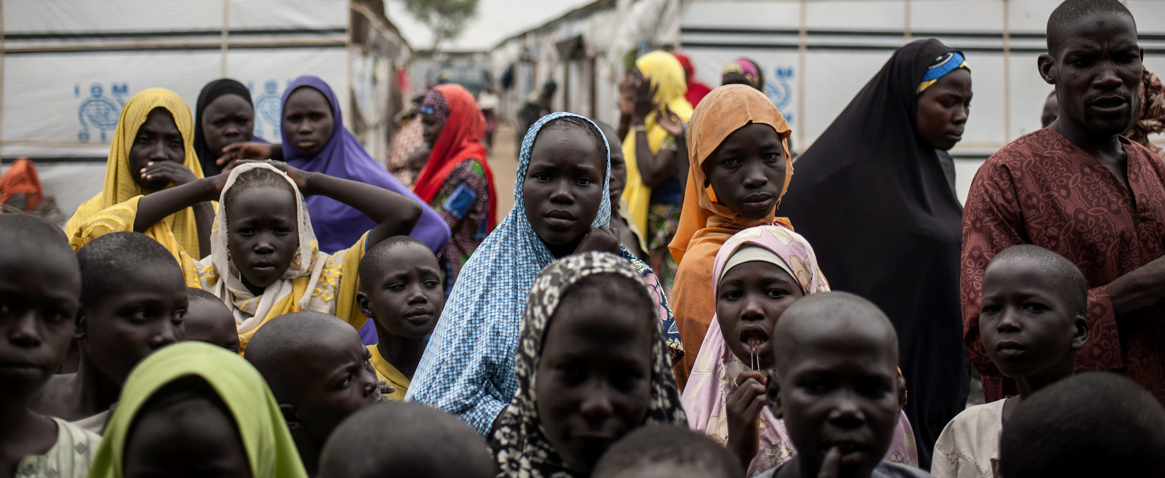 In northeast Nigeria, people fleeing or recently escaped from Boko Haram shelter in a devastated town turned military base, awaiting humanitarian aid | STEFAN HEUNIS/AFP/Getty Images