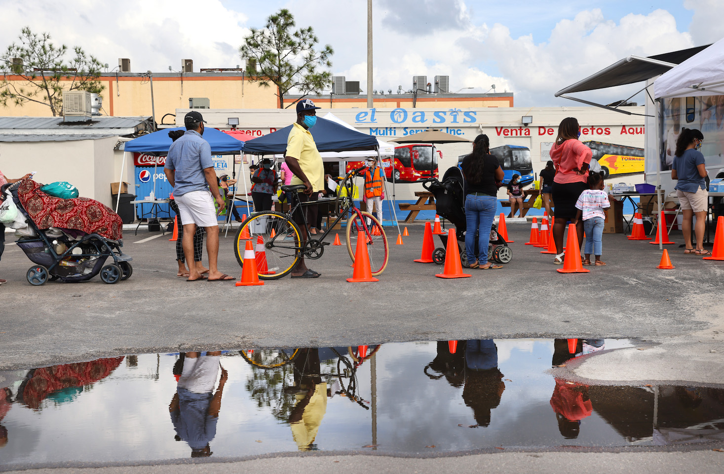 People wait in line in Immokalee, Florida for services from the Coalition of Immokalee Workers and Partners in Health to test, educate and vaccinate the poverty-stricken community during the Covid-19 outbreak. | Spencer Platt/Getty Images