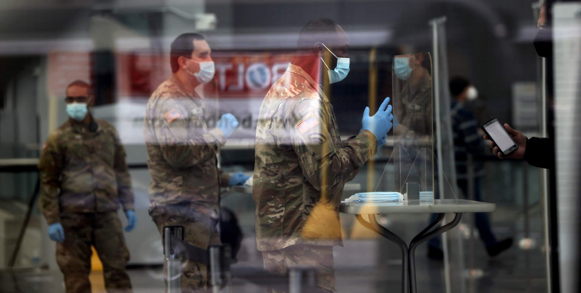 Members of the National Guard assist people getting vaccinated at the Javits Center which opened as a Covid-19 vaccination site on January 13, 2021 in New York City. | Spencer Platt/Getty Images