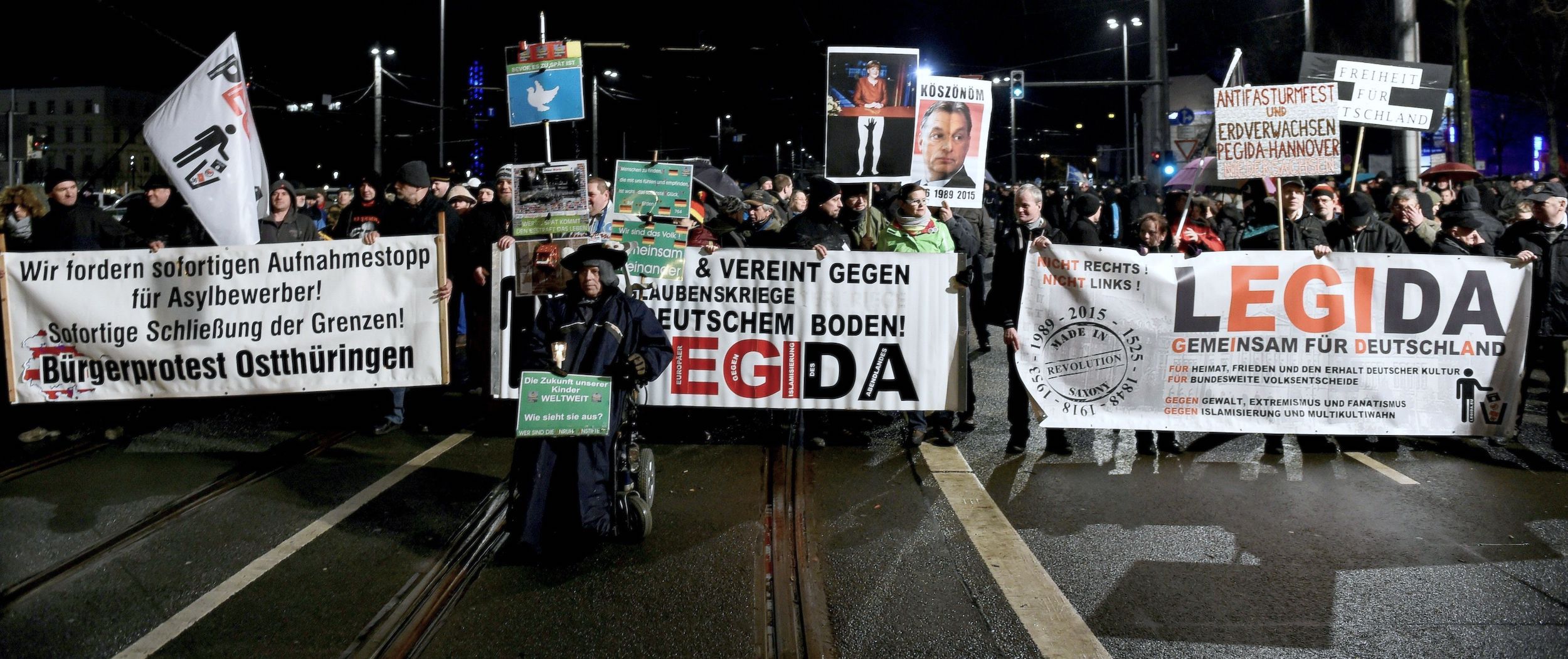Anti-immigrant protestors march down a street in Berlin. | TOBIAS SCHWARZ:AFP via Getty Images