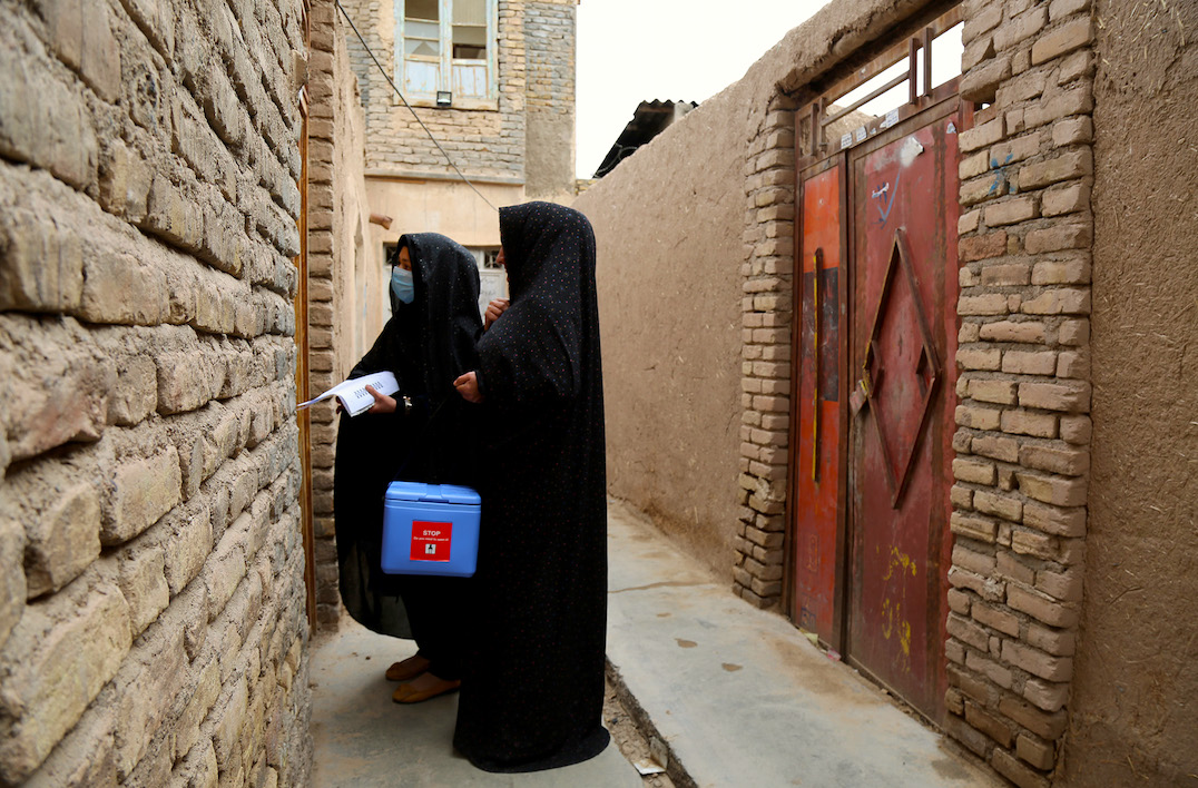 vaccinators from the Afghanistan polio eradication initiative go door to door seeking permission to vaccinate every child