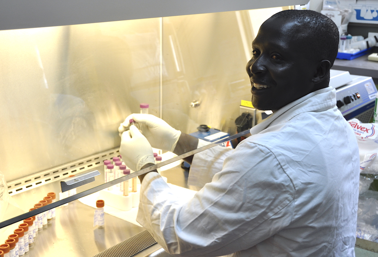 A lab technician in Kenya works with samples to test for poliovirus.