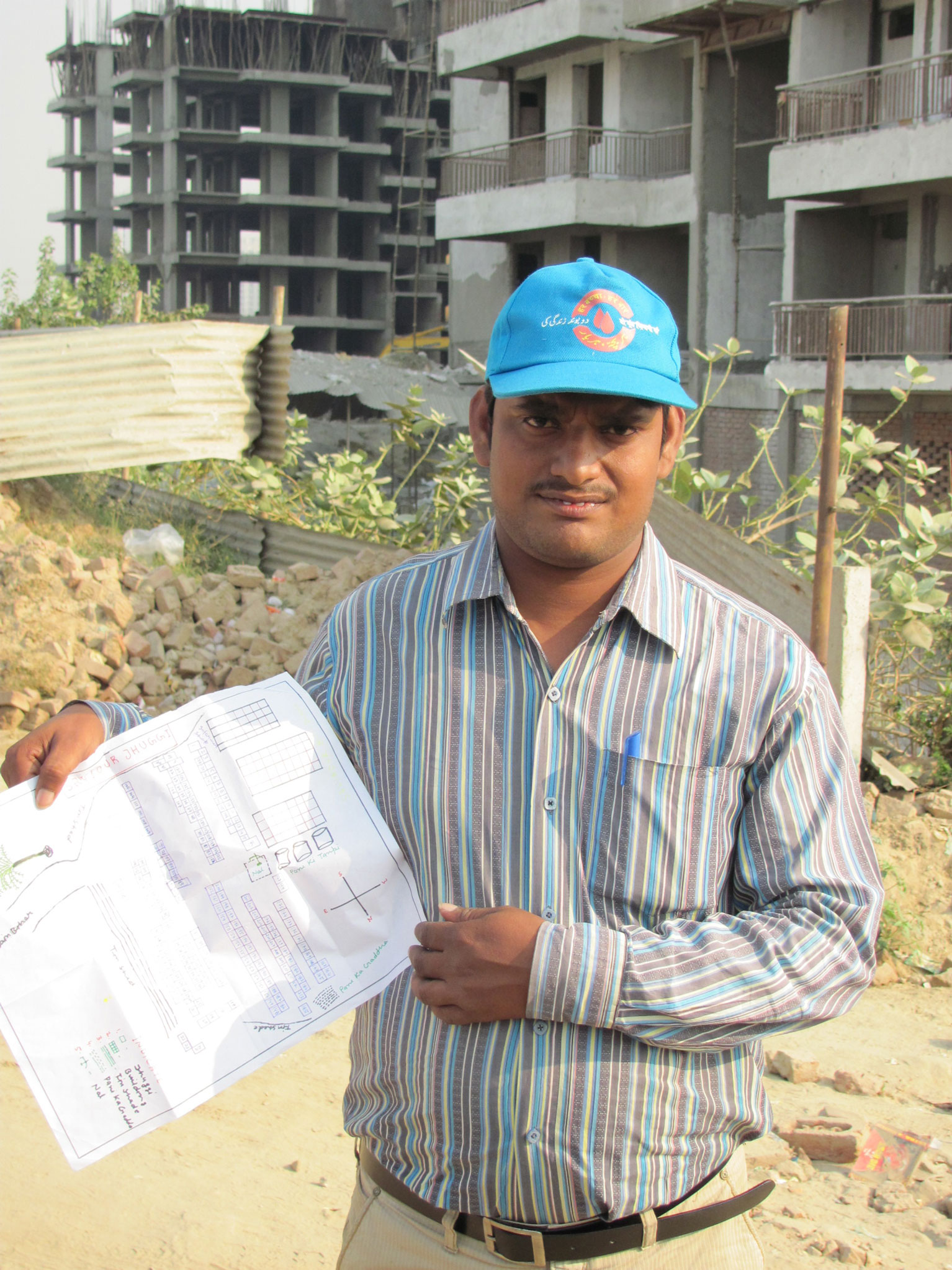 Vaccinator with map of households in the community