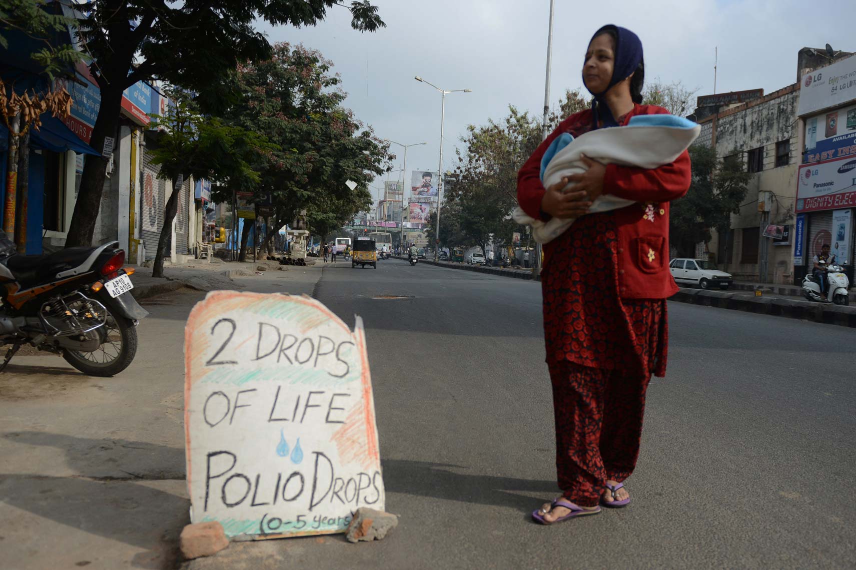 A woman brings her baby to be vaccinated
