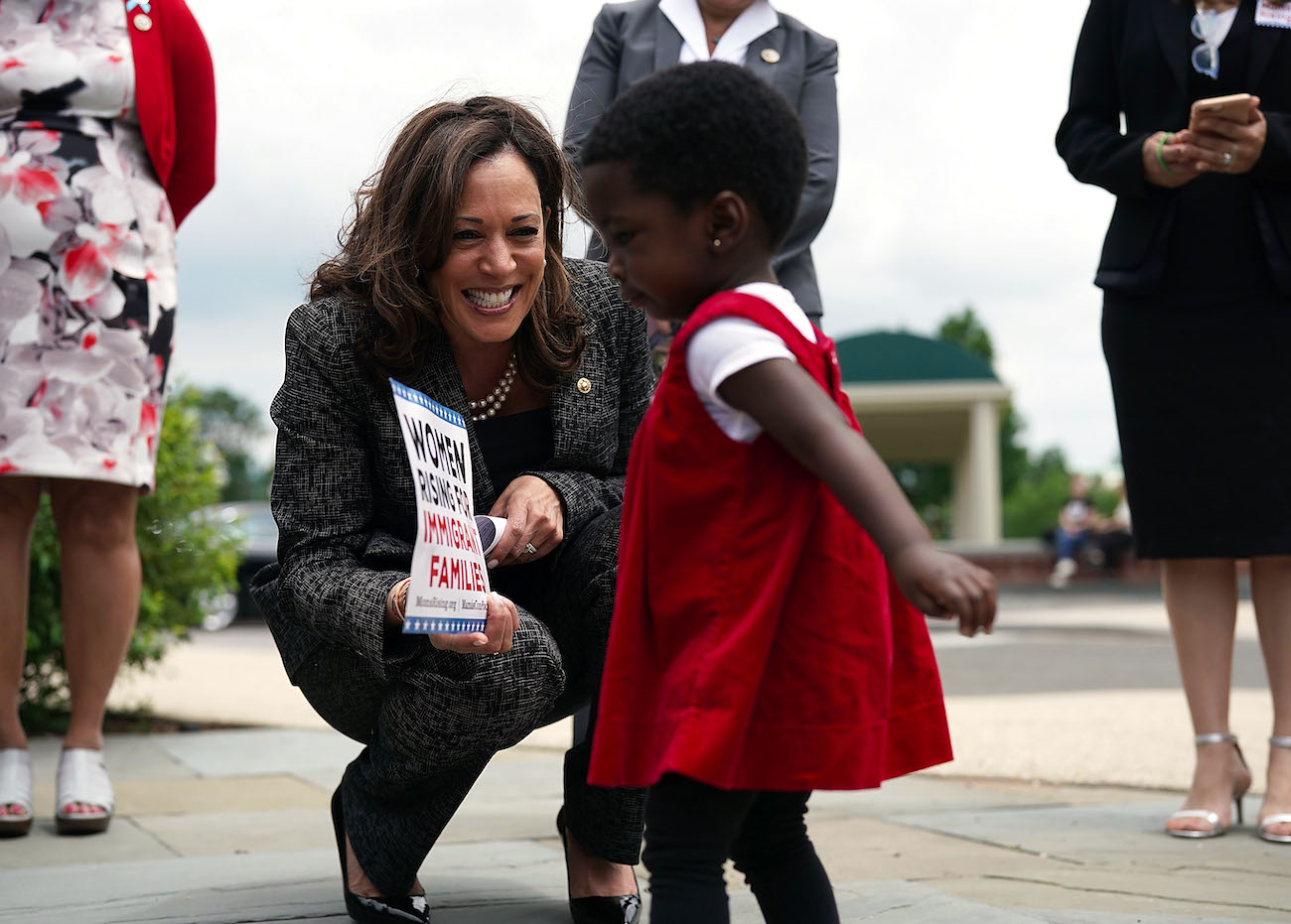 Vice President Elect Kamala Harris plays with 18-month-old Hawa Tembe (R), whose mother is an immigrant from Mozambique, during a 2018 news conference to "to show support for immigration and refugee policies that protect the rights and safety of women and children." | Alex Wong/Getty Images