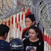 Uighur woman (C) going through an entrance to a bazaar in Hotan, in China's northwest Xinjiang region