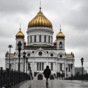 A woman walks in front of Christ-the-Savior cathedral in Moscow on June 2, 2020, amid the outbreak of COVID-19. | ALEXANDER NEMENOV/AFP via Getty Images