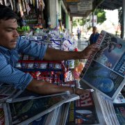 A newspaper seller in Southeast Asia