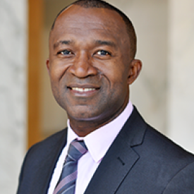 a person in a suit smiling
