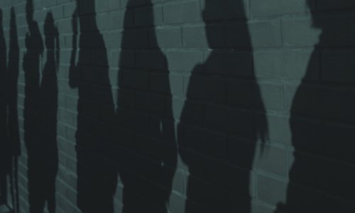 Shadow people on brick wall