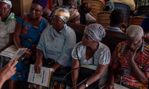 A nurse informs patients in Ghana about malaria and the new vaccine against it.
