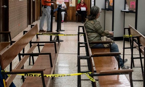 People wait, socially distanced, to be cared for at a clinic in Costa Rica.