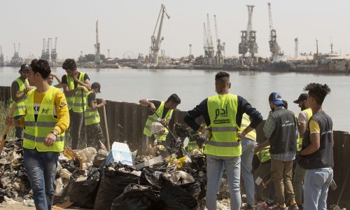 aqi volunteers take part in a waste clean up campaign on Sinbad Island.