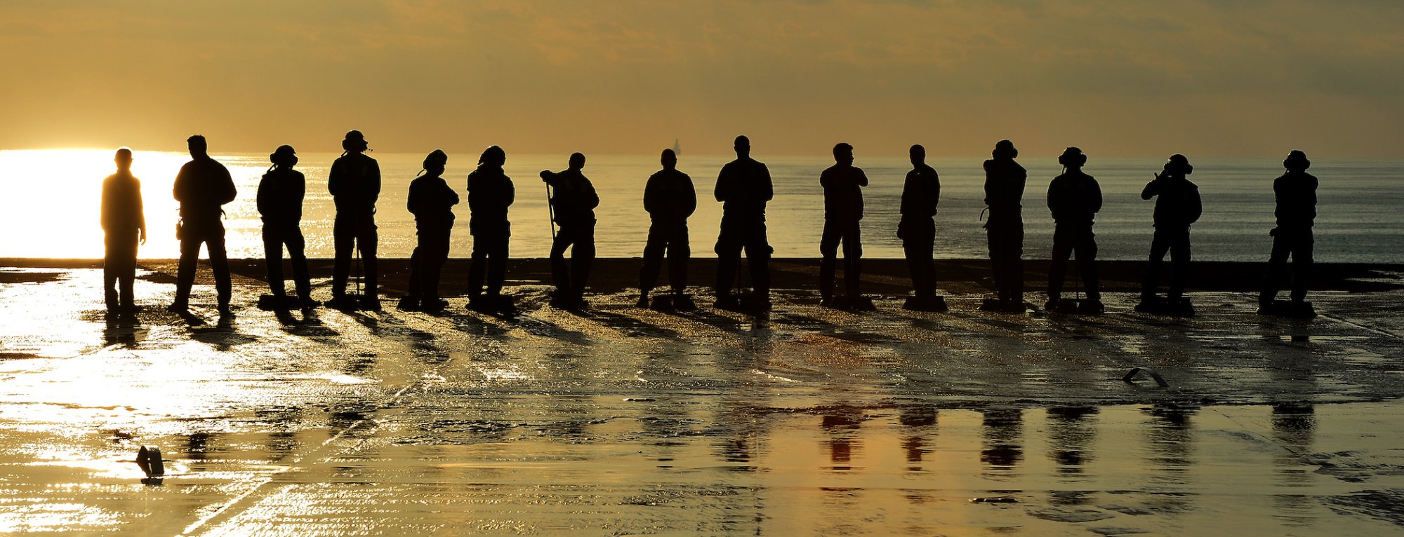 U.S. Navy personnel clean the flight deck of the USS Nimitz (CVN 68) aircraft carrier in the Mediterranean Sea in October 2013. 