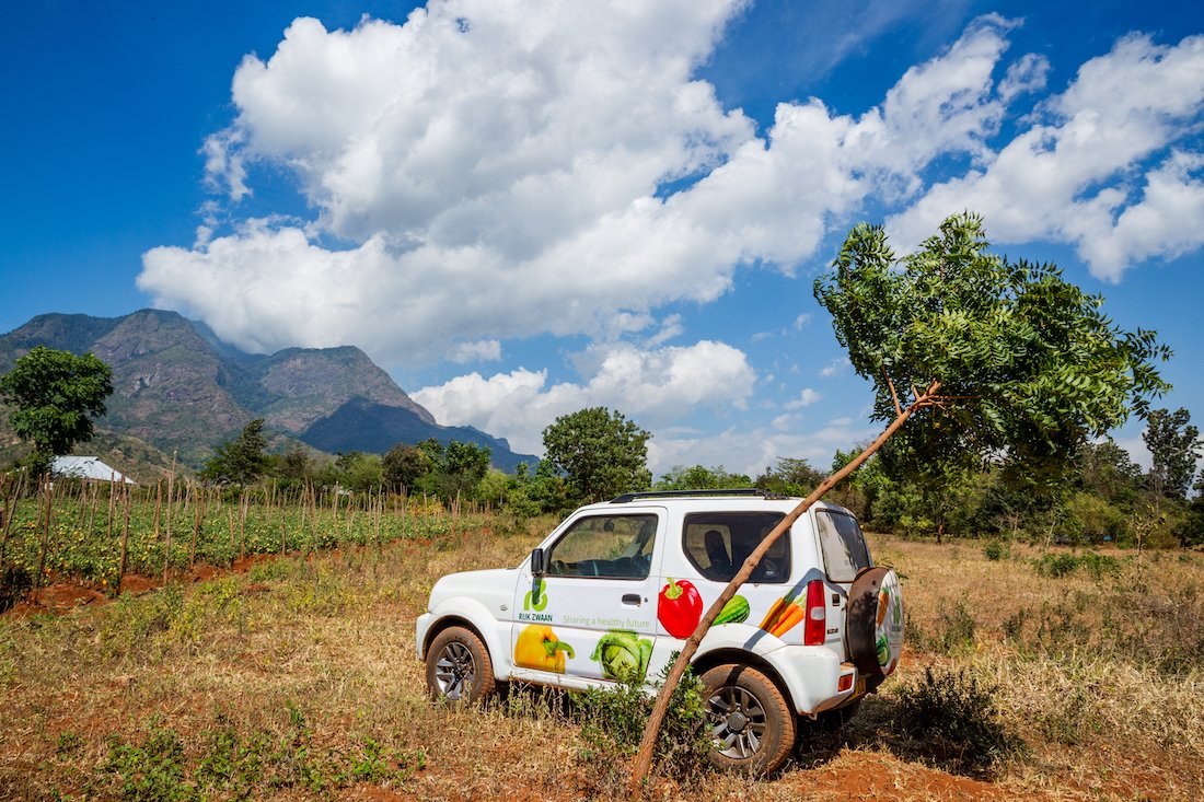 A nutrition NGO jeep in a crop field