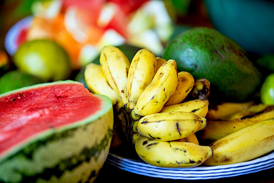 Bananas, melons and other fruits on a table