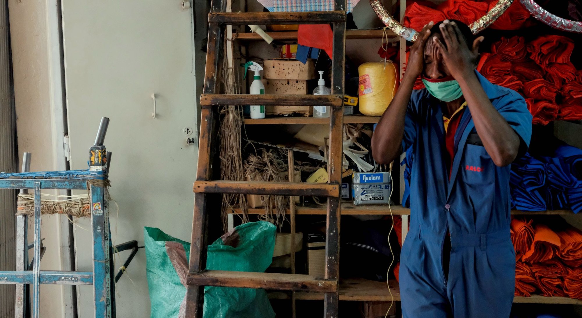 An employee washes is hands and face inside a bicycle shop in Nairobi. | KABIR DHANJI/AFP via Getty Images