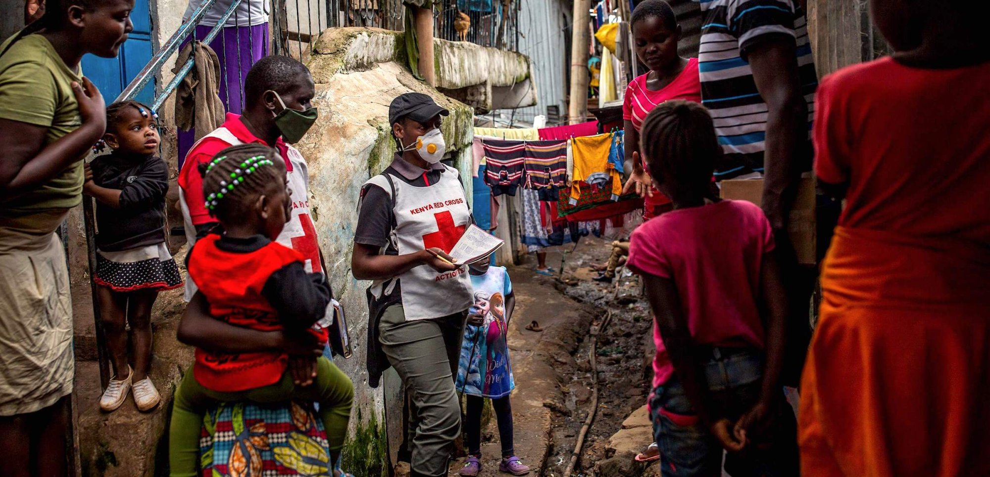 Staff members of the Kenyan Red Cross deliver hand disinfectants to residents to curb the spread of the COVID-19 coronavirus at Mathare slum in Nairobi, Kenya, on May 1, 2020.  | PATRICK MEINHARDT/AFP via Getty Images