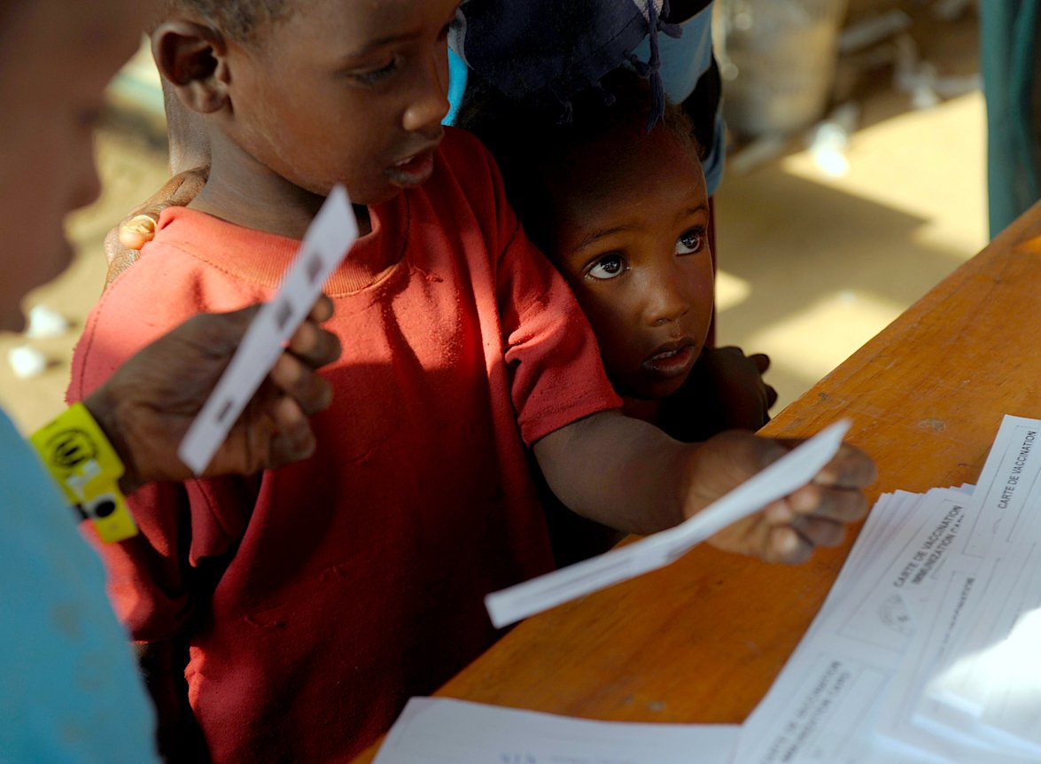 Child refugees receive their vaccination certificates after they were immunized at Dadaab refugee camp in northeastern Kenya. | ROBERTO SCHMIDT/AFP via Getty Images