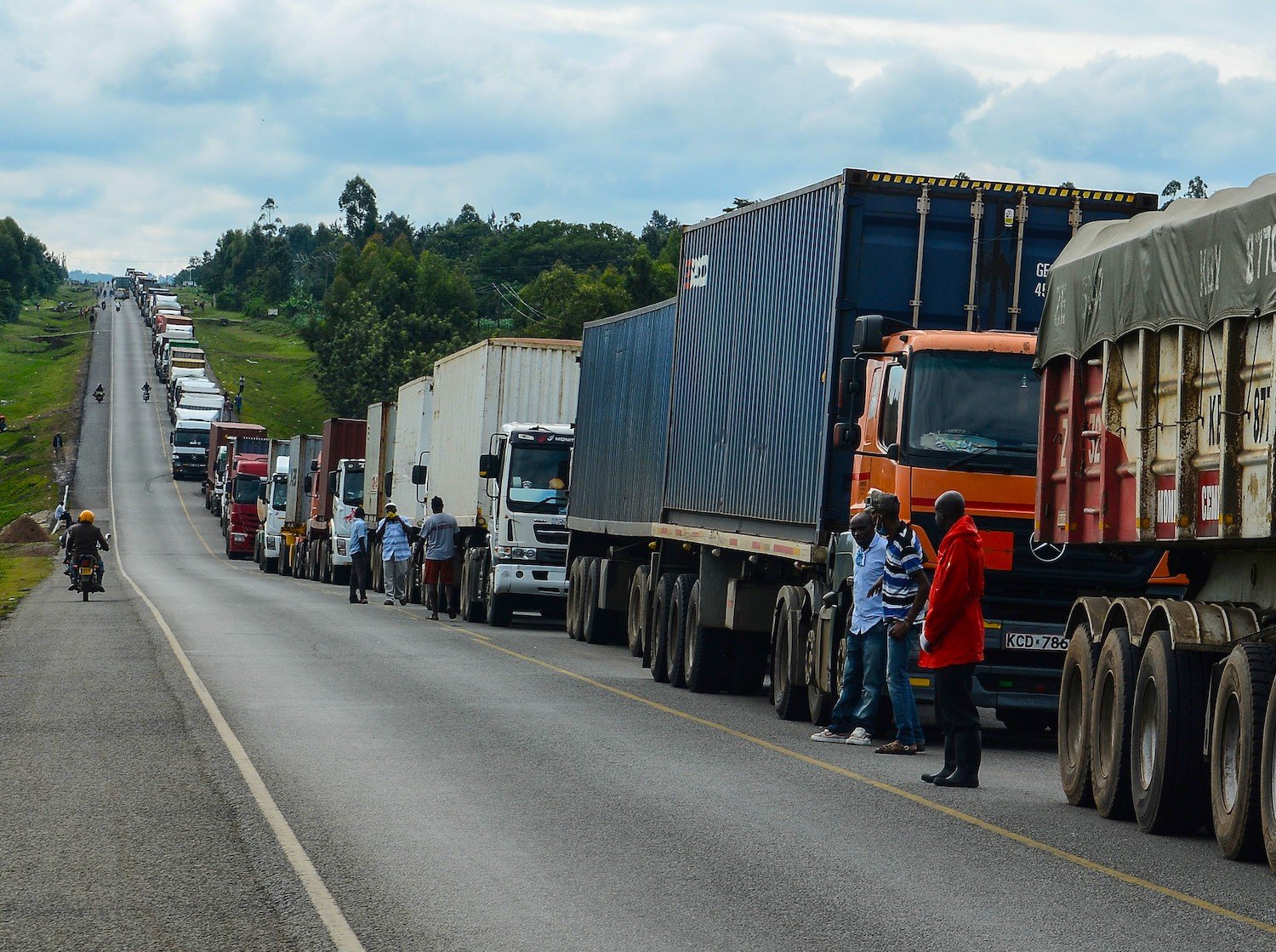 Trucks wait in a line on the road to enter Uganda in Malaba, a city bordering with Uganda, western Kenya, on April 29, 2020. 