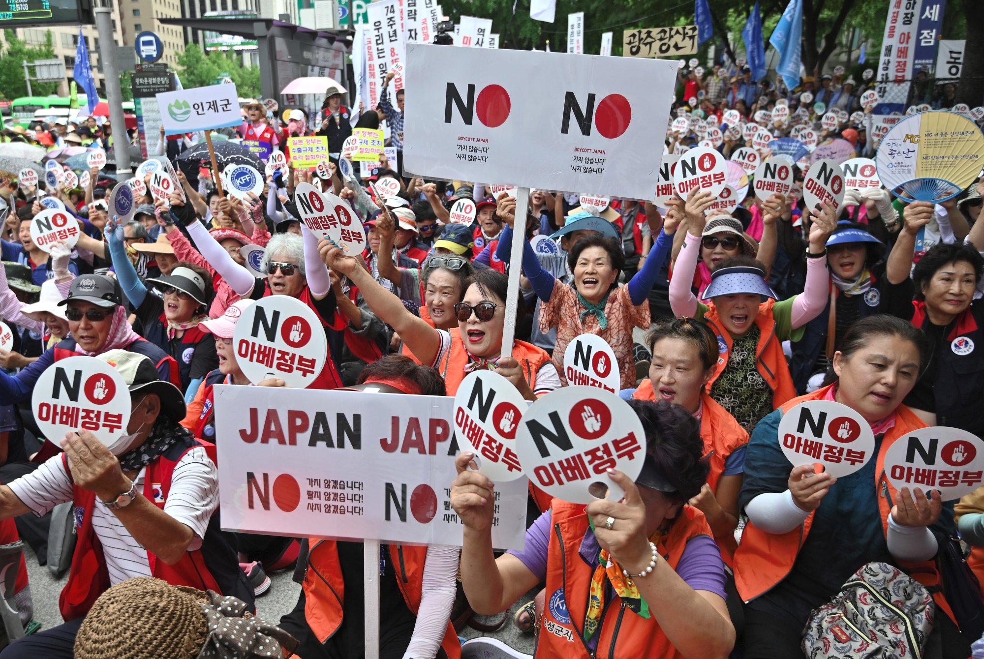 South Korean protesters hold up signs reading “No Abe’s government” during an anti-Japanese rally in central Seoul on August 13, 2019.(Photo by JUNG YEON-JE/AFP via Getty Images.)