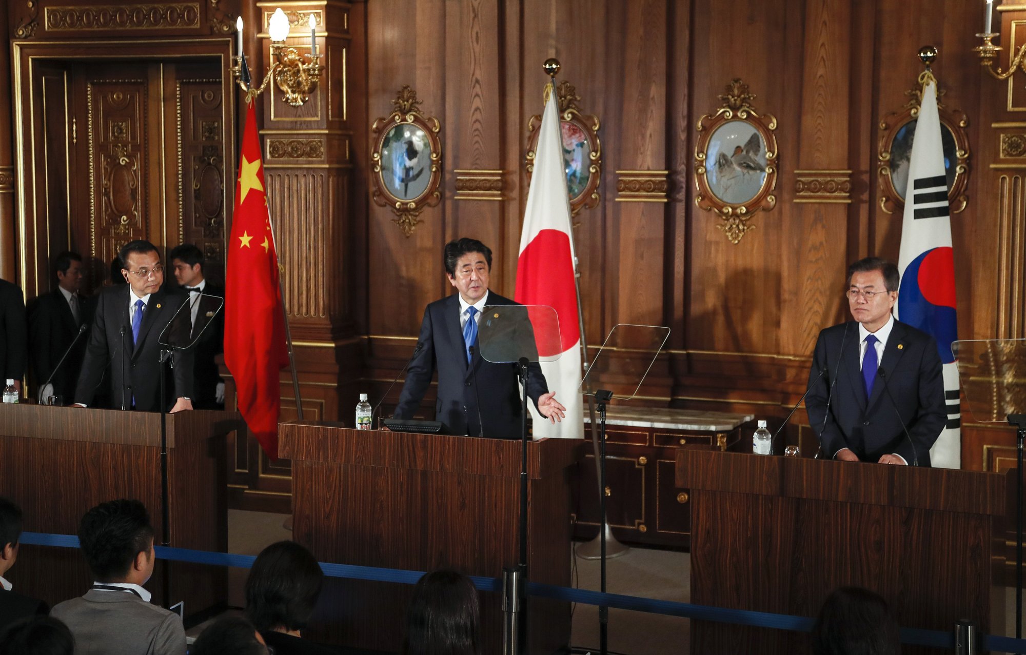 Then-prime minister Shinzo Abe (C), China's prime minister Li Keqiang (L), and South Korea's president Moon Jae-in (R) attend a joint news conference following their trilateral summit talks in Tokyo on May 9, 2018. (Photo by KIMIMASA MAYAMA/AFP via Getty Images.)